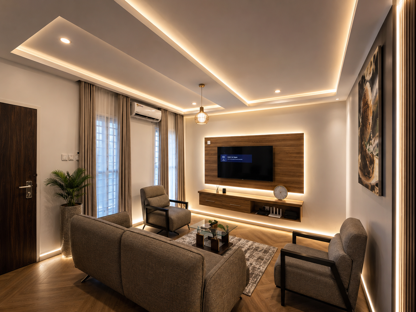 Furnished living room of the Aston home in Gaduwa, Abuja, with wall-mounted television, warm cove lighting and herringbone flooring