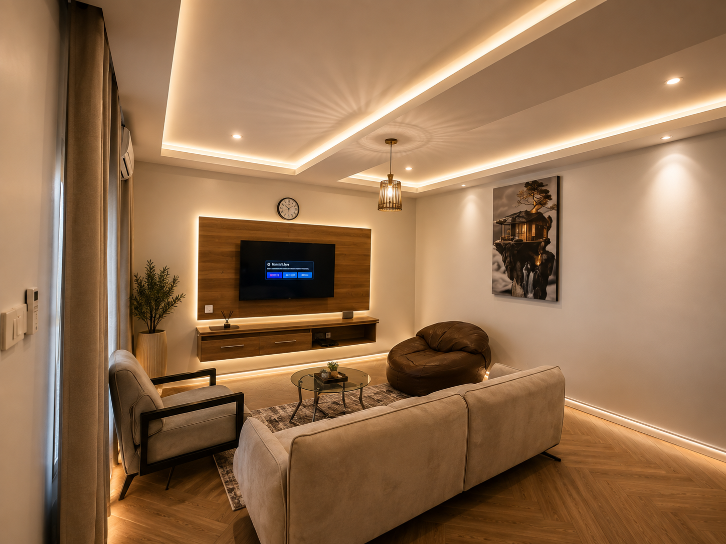Second view of the living room in the Aston Gaduwa home, showing seating, television wall and artwork